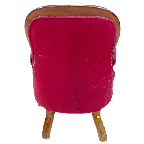 262 - A pair of Victorian mahogany buttonback nursing chairs, upholstered in a claret material, with cushi... 