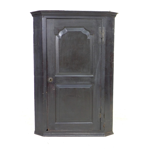 270 - A George III oak corner cupboard, with a single flat front fielded panel door, fixed shelves to inte... 