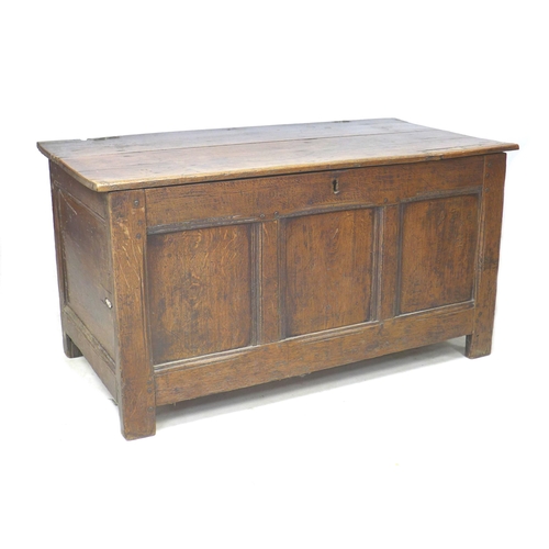 273 - An 18th century three panelled oak coffer, with lift lid, raised on straight legs, modern brass hing... 