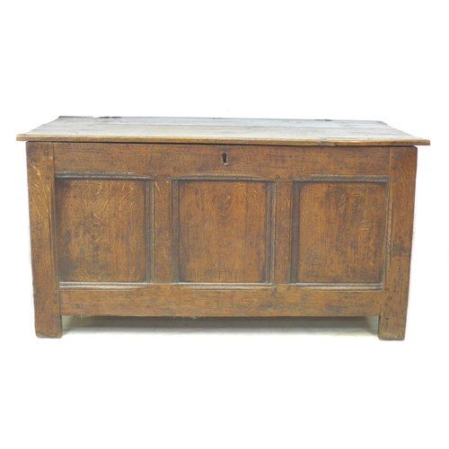 273 - An 18th century three panelled oak coffer, with lift lid, raised on straight legs, modern brass hing... 