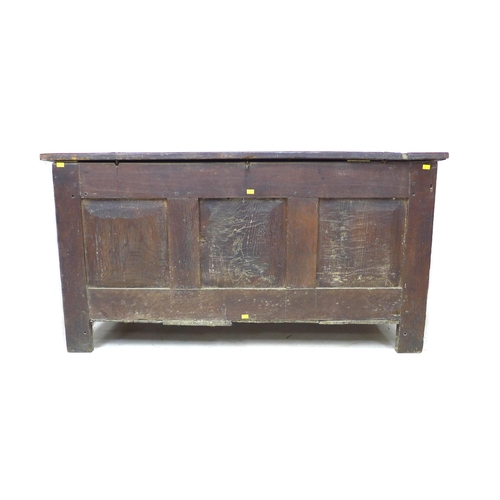 273 - An 18th century three panelled oak coffer, with lift lid, raised on straight legs, modern brass hing... 