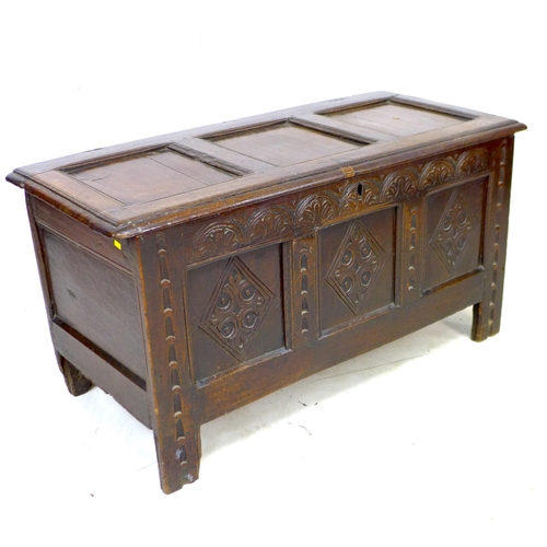 277 - A 17th century oak chest, lift top over a three panel front carved with diamonds and lunettes, raise... 