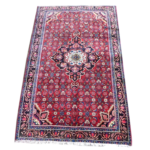 278 - A Hamadan rug, caucasian medallion on red ground with floral design, and dark blue ground borders, 2... 