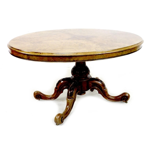 279 - A Victorian burr walnut loo table, with oval tilt top, carved baluster column and four carved cabrio... 