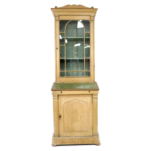 283 - A 19th century French stripped pine bureau bookcase, with shaped pediment over a single glazed door,... 