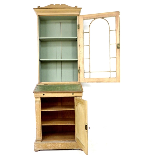 283 - A 19th century French stripped pine bureau bookcase, with shaped pediment over a single glazed door,... 