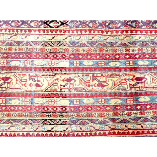 290 - An Araak rug, profuse geometric decoration upon a red ground with multi-coloured ground borders, 365... 