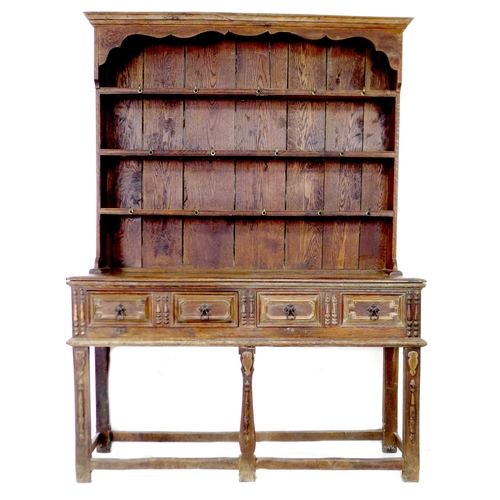 293 - An 18th century oak dresser, the closed back plate rack with three shelves fitted with brass hooks, ... 