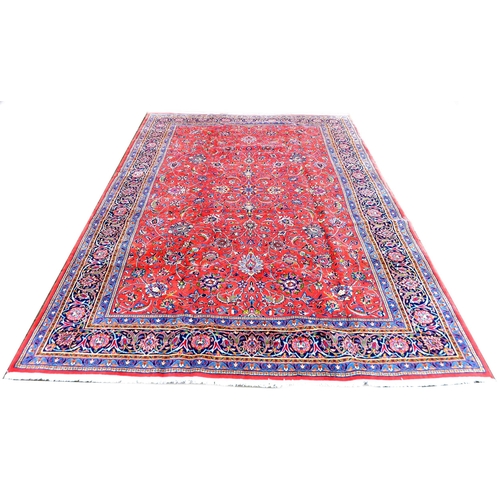 295 - A Sarough rug, with floral design across central red ground and dark blue ground borders, 350 by 250... 