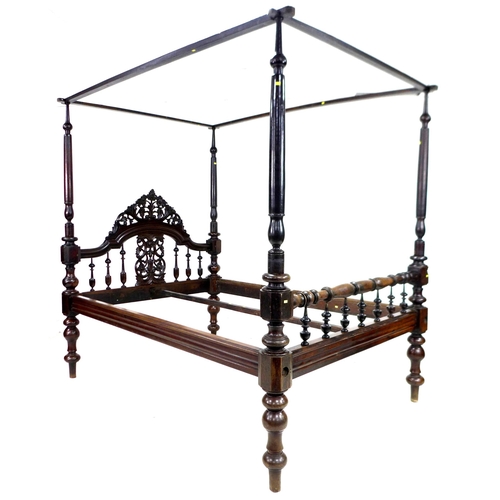 296 - A 19th century mahogany four poster bed, with foliate carved and pierced arched headboard, the footb... 