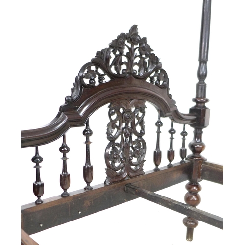 296 - A 19th century mahogany four poster bed, with foliate carved and pierced arched headboard, the footb... 