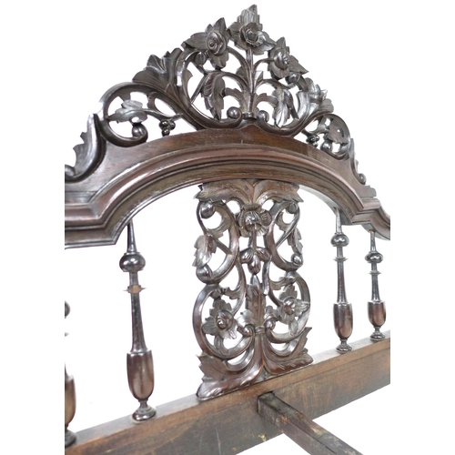 296 - A 19th century mahogany four poster bed, with foliate carved and pierced arched headboard, the footb... 