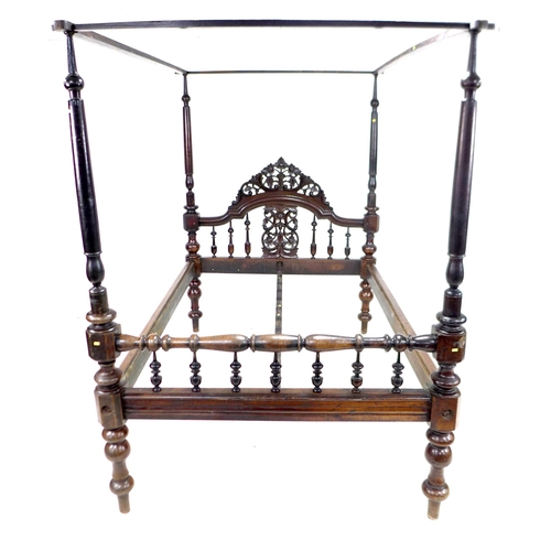 296 - A 19th century mahogany four poster bed, with foliate carved and pierced arched headboard, the footb... 