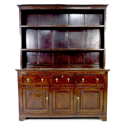 297 - A George III oak dresser, the closed back plate rack with two shelves, the base section with three f... 