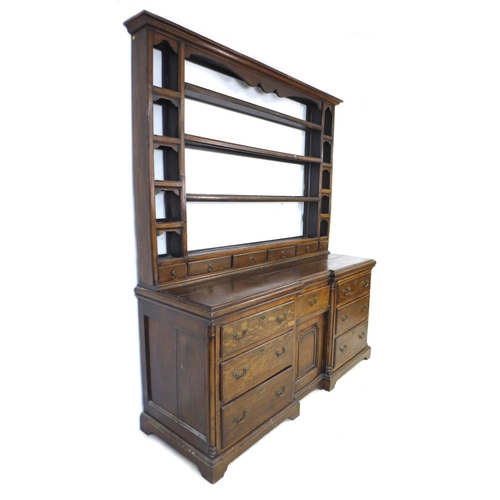 299 - A George II oak dresser, the rack with three shelves above six short drawers flanked by compartments... 