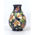 A Moorcroft pottery Amber Glow pattern limited edition vase, in baluster form, signed Seb Leeper and... 