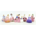A group of seven Royal Doulton figures, comprising 'The Bedtime Story', HN2059, 12.5cm high, 'Peggy'... 
