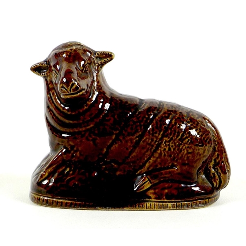 65 - A rare Newcastle pottery figure, 17th / 18th century, modelled as a recumbent sheep, all over treacl... 