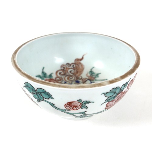 44 - A Chinese porcelain bowl, late 19th / early 20th century, decorated with blue foo dogs amongst red f... 