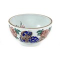 A Chinese porcelain bowl, late 19th / early 20th century, decorated with blue foo dogs amongst red f... 