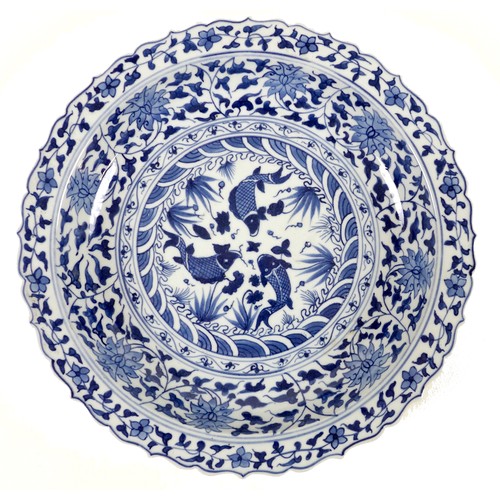 47 - A Chinese Ming style blue and white porcelain dish, late 20th century, with scalloped rim, decorated... 
