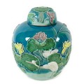 A Chinese porcelain ginger jar and cover, in the style of Wang Bingrong Zuo, with applied lotus flow... 