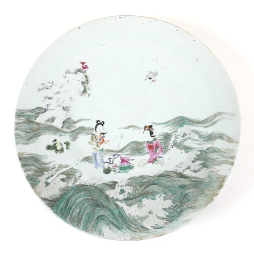 39 - A Chinese porcelain charger, 19th century, decorated in famille verte palette with two ladies amongs... 