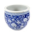 A Chinese porcelain fish bowl, decorated in underglaze blue with prunus blossom against a cracked ic... 
