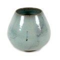 A Chinese pottery vase, decorated in an allover green glaze with asymmetric glaze line to lower rim,... 