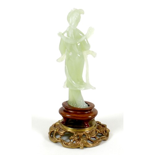 15 - A Chinese carved jade figure, late 20th century, modelled as a lady in standing pose, on a turned wo... 