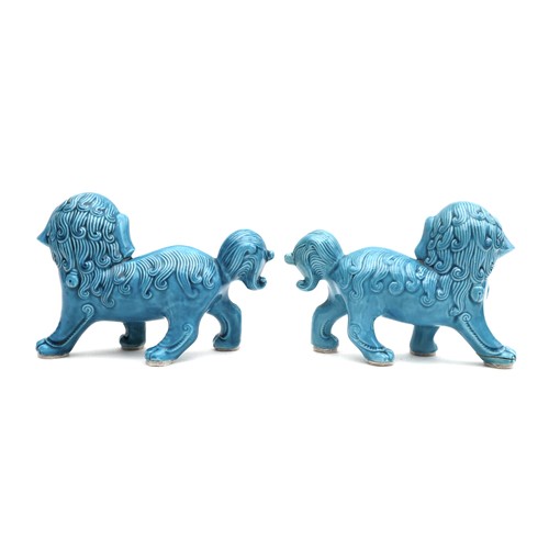9 - A pair of modern Chinese turquoise glazed figures, modelled as Buddhistic lion dogs, 16.5 by 7 by 11... 