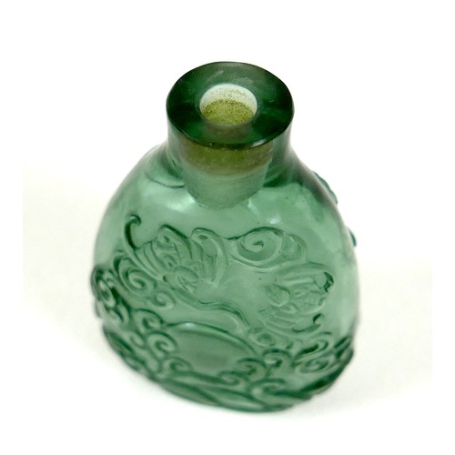 34 - A Chinese carved glass scent bottle, depicting an eagle amongst scrolling clouds, incised mark to ba... 