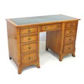 An Edwardian satinwood pedestal desk, the surface with a gilt tooled leather insert, above a series ... 