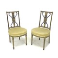 A pair of Napoleon III side chairs, the circular seats covered in a gold dralon fabric with beaded e... 