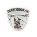 A Chinese porcelain tea bowl, Kangxi mark and period, decorated in famille verte palette with four p... 