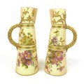 A pair of Royal Worcester jugs, circa 1906, shape 1047, the peach ground painted with summer flowers... 