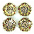 A set of four Royal Crown Derby Imari dishes, 1128, with scalloped edges and richly gilded, 11 by 11... 