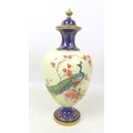 A Royal Worcester vase and cover, painted with a peacock perched on a branch in a blossom tree, on c... 