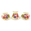 Three pieces of Royal Worcester by Kitty Blake, comprising a pair of globular vases, 7cm high, toget... 
