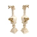 A pair of 19th century alabaster urns, the spouts carved as a birds beaks, with moulded flower and l... 