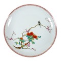 A Chinese porcelain dish, mid 20th century, decorated in enamels with a bird on a blossoming branch,... 