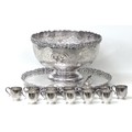 An impressive silver plated punch set, comprising a large punch bowl, decorated with chased scrollin... 