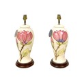 A pair of late 20th century Moorcroft magnolia pattern electric lamp bases, both 37cm high overall. ... 