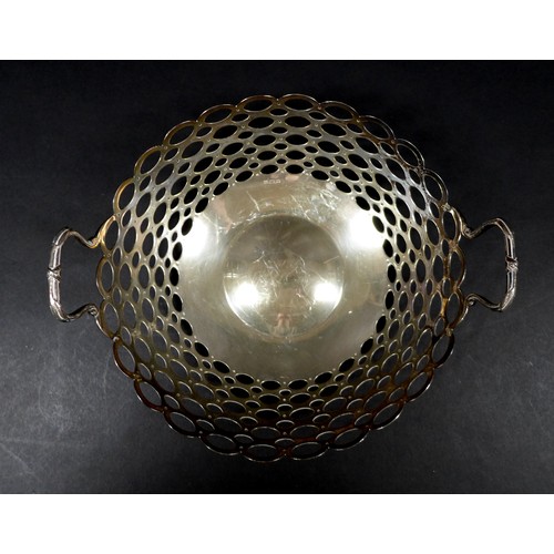 83 - A George V twin handled silver fruit bowl, of circular form with pierced looped decoration, with rub... 