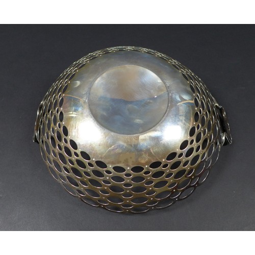 83 - A George V twin handled silver fruit bowl, of circular form with pierced looped decoration, with rub... 