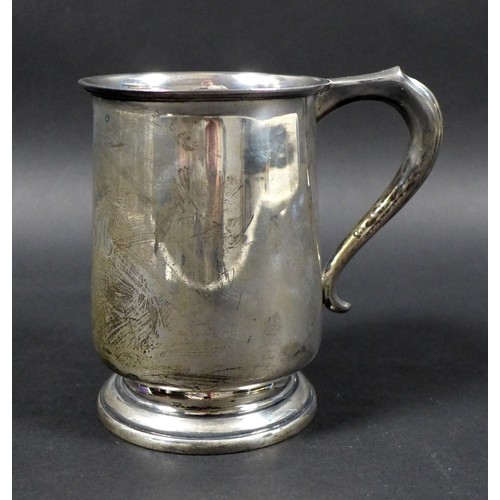 31 - A George VI silver tankard, engraved with initials, possibly 'J.W.M', scroll handle raised upon a st... 