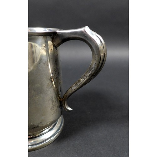 31 - A George VI silver tankard, engraved with initials, possibly 'J.W.M', scroll handle raised upon a st... 