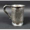 A George VI silver tankard, engraved with initials, possibly 'J.W.M', scroll handle raised upon a st... 