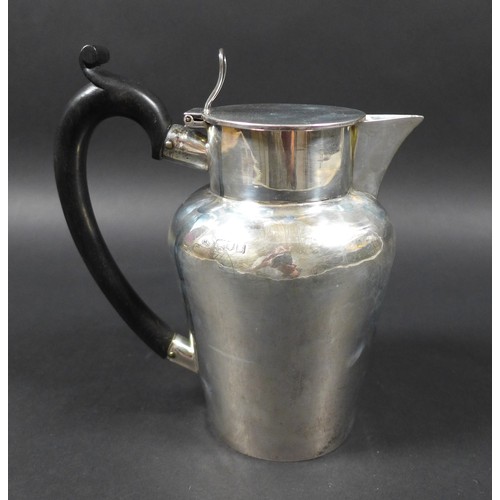 61 - An Edwardian silver hot water jug, with ebonised handle, hinged lid, Charles Boyton (III), London 19... 