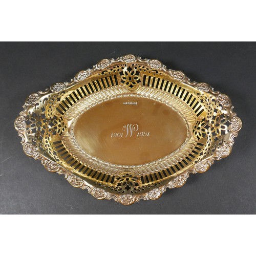30 - An Edwardian silver gilt commemorative bowl, of boat form with pierced sides and repousse scrolls to... 